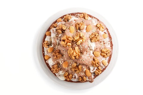 Homemade cake with milk cream, cocoa, almond, hazelnut isolated on white background. Top view, flat
