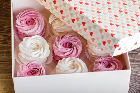 White box with pink and white homemade zephyr on gray wooden background