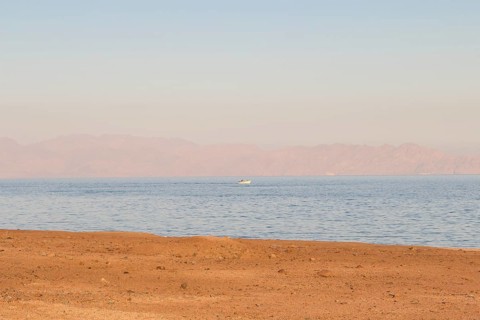 The coastline of the Red Sea and the mountains in the background, sunset. Egypt, the Sinai