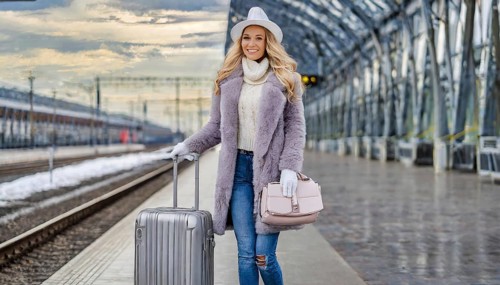 AI generated, A young blonde woman wants to travel and waits in the station for the train, 20, 25,