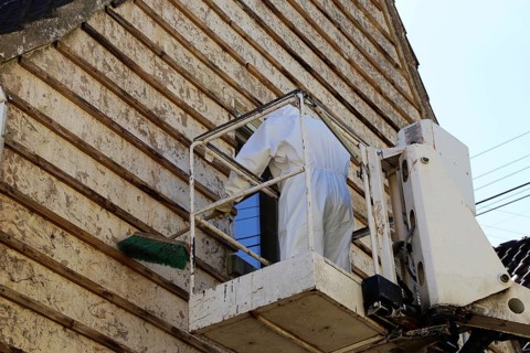 Professional asbestos removal by workers in protective suits