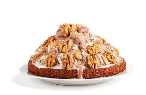 Homemade cake with milk cream, cocoa, almond, hazelnut isolated on white background. Side view,