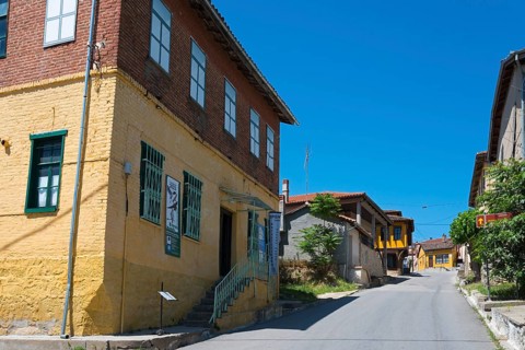 Charming cobbled street with rustic, colourful houses in an old town, Koukoulospito, house with