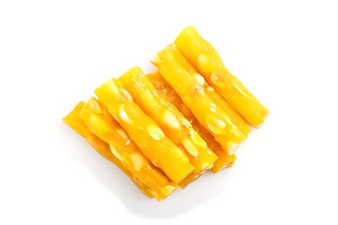Yellow traditional turkish delight (rahat lokum) with peanuts isolated on white background. top