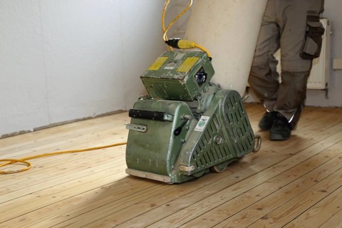 A parquet floor is sanded and oiled