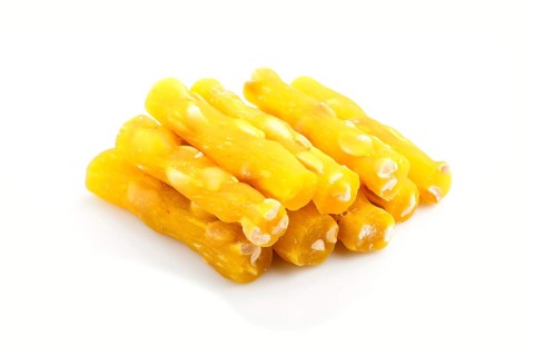 Yellow traditional turkish delight (rahat lokum) with peanuts isolated on white background. side