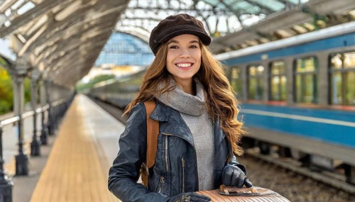 AI generated, A young blonde woman wants to travel and waits for the train at the station, 20, 25,