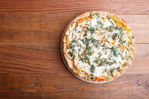 Sweet pumpkin pie with cheese and dill on brown wooden background. top view. copy space