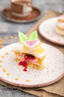 Decorated cake with milk and coconut cream with cup of coffee on a gray wooden background and linen