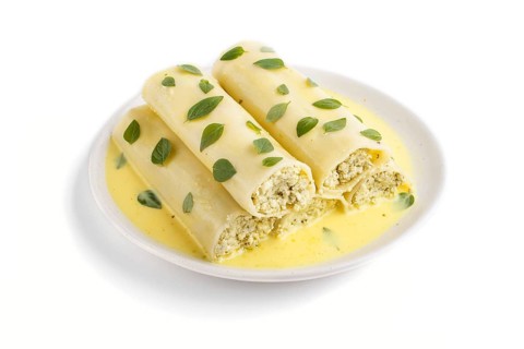 Cannelloni pasta with egg sauce, cream cheese and oregano leaves isolated on white background. side