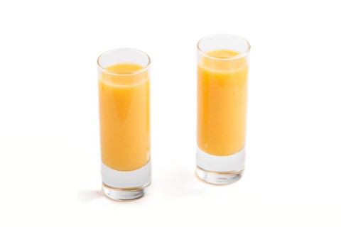 Sweet egg liqueur in glass isolated on white background. Side view, close up