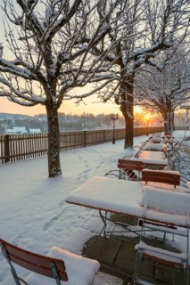 Snow-covered beer garden in winter, sunset, Andechs Monastery, Fuenfseenland, Pfaffenwinkel, Upper