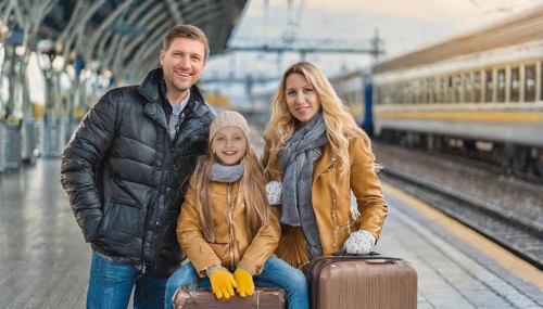 AI generated, A young family wants to travel and waits in the station for the train, 30, 35, years,