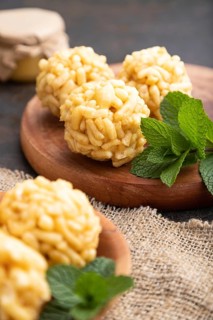Traditional Tatar candy chak-chak made of dough and honey with cup of coffee on a black concrete