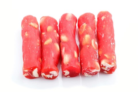 Red traditional turkish delight (rahat lokum) with peanuts isolated on white background. side view,