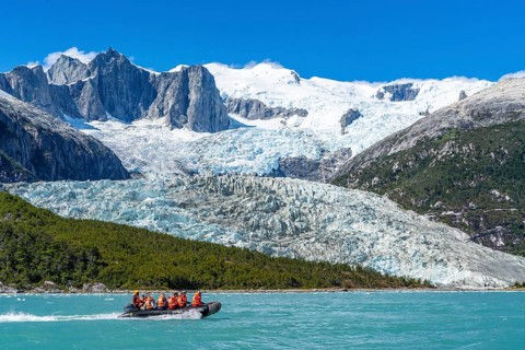 Passengers of the cruise ship Stella Australis travelling in a rubber dinghy in front of the Pia