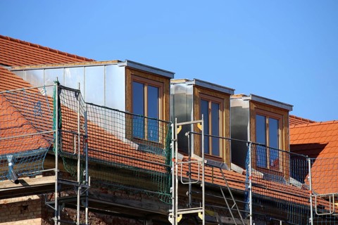 Roofer working on a new dormer window