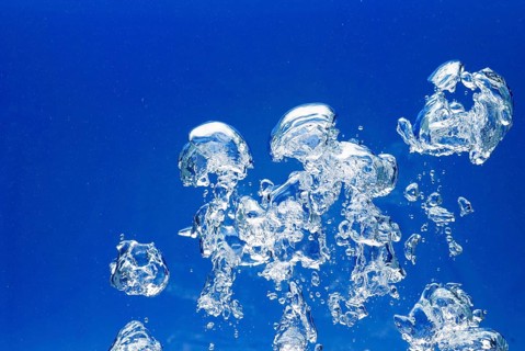 Bright Air bubbles, blue background in an aquarium