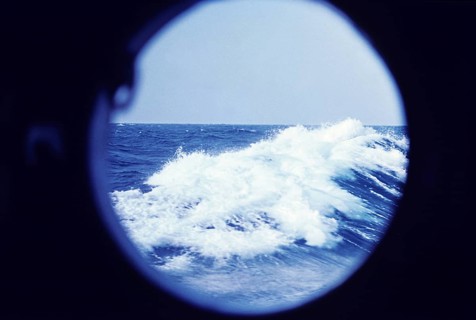 Ocean wave seen through a porthole