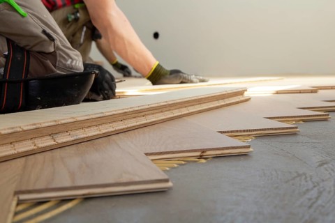 Craftsmen laying herringbone parquet professionally
