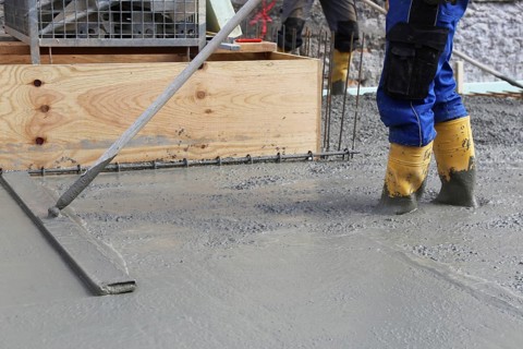 Concreting a floor slab with ready-mixed concrete on the construction site of a residential