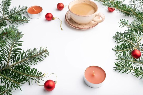 Christmas or New Year frame composition. Decorations, red balls, fir and spruce branches, cup of