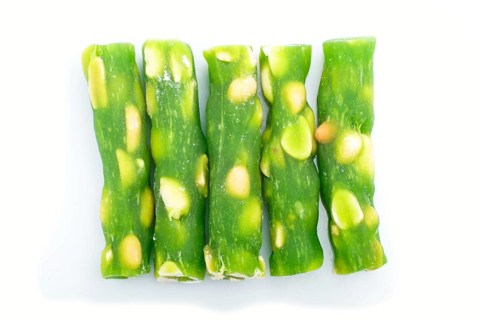 Green traditional turkish delight (rahat lokum) with peanuts isolated on white background. top
