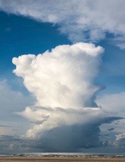 Rain cloud (Cumulonimbus capillatus) with heavy rain shower on the North Sea beach, Henne Molle,