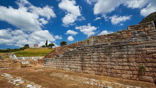 Historic remains of ancient walls against a cloudy sky and green landscape, Ancient city wall,
