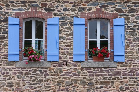 Two windows in a granite house, blue shutters, floral decoration, Pontrieux, Departement Cotes