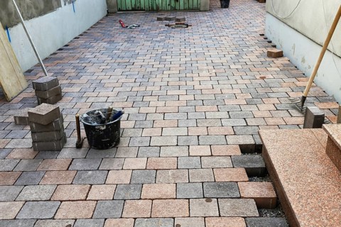 Worker lays paving stones