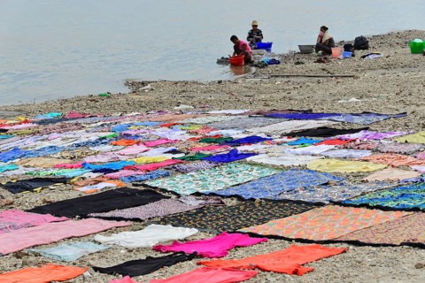 Washing clothes in the Irrawaddy, Myanmar, Asia