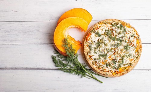 Sweet pumpkin pie with cheese and dill on white wooden background. top view. copy space
