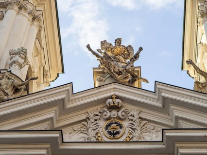 Sculpture, depiction of a saint on the gable of the church, Archangel Michael pushing Lucifer into