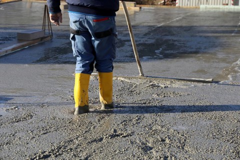 Concreting a floor slab with ready-mixed concrete on the construction site of a residential