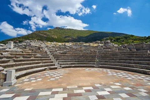 Sunny view of the ancient theatre with a view of the stage and the rows of seats, Asklepios