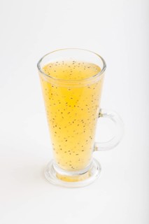 Glass of tangerine orange colored drink with basil seeds isolated on white background. Morninig,