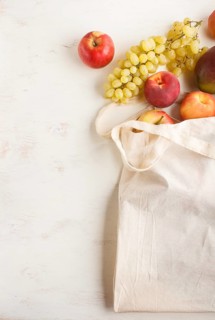 Fruits in reusable cotton textile white bag. Zero waste shopping, storage and recycling concept,