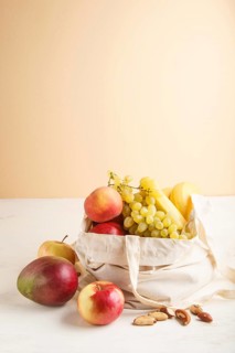 Fruits in reusable cotton textile white bag. Zero waste shopping, storage and recycling concept,