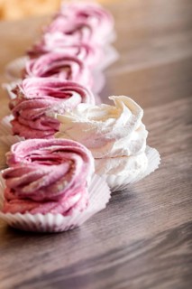Pink and white homemade marshmallows on a gray wooden background. selective focus
