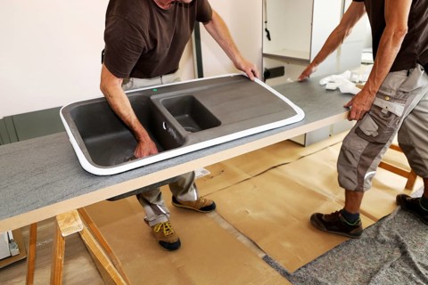 Craftsmen installing a new kitchen (kitchen assembly)