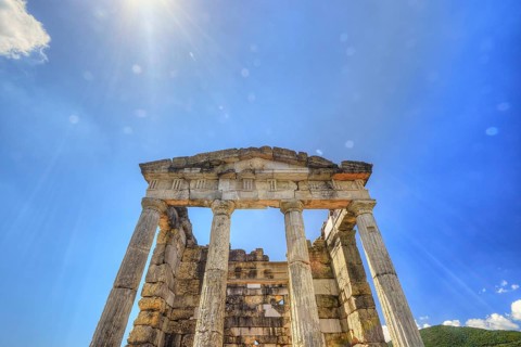 Sky-blue background behind the imposing remains of an ancient temple, Mausoleum, Heroon,