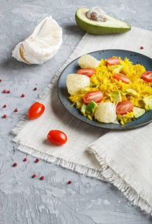 Fried pomelo with tomatoes and avocado on gray concrete background. side view, myanmar food