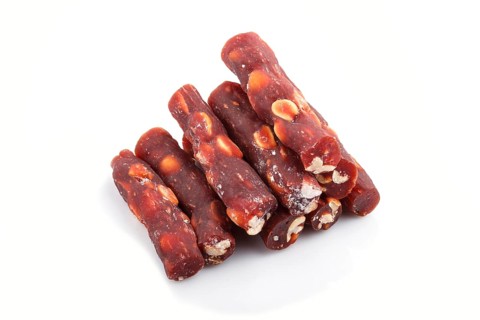 Brown traditional turkish delight (rahat lokum) with peanuts isolated on white background. side