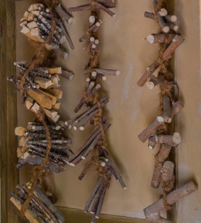 Pieces of wood used to make oriental medicine tied together with hemp rope and hanging on wall in