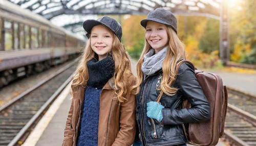 AI generated, Two young blonde woman want to travel and wait in the station for the train, 18,