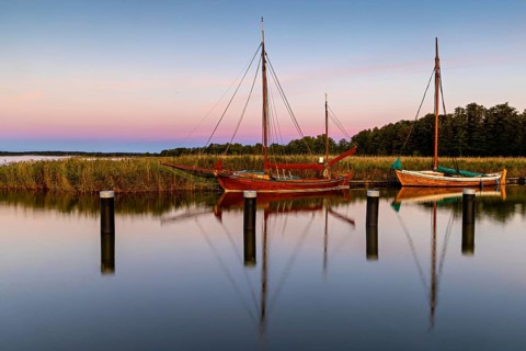 Old sailing boats in the harbour of Wieck on the Darss in the morning light