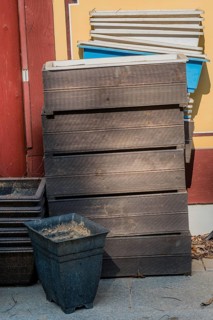Disused wooden and plastic planter boxes outdoors against wall of building in South Korea