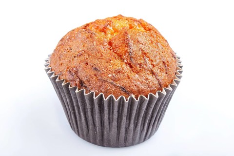 One carrot muffin isolated on white background. closeup
