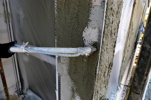 Plasterer plastering an exterior wall